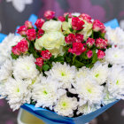 Red and White Flower Bouquet in Blue Vase on Purple Background
