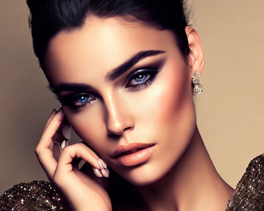 Striking blue-eyed woman in bold makeup and gold dress with winged eyeliner