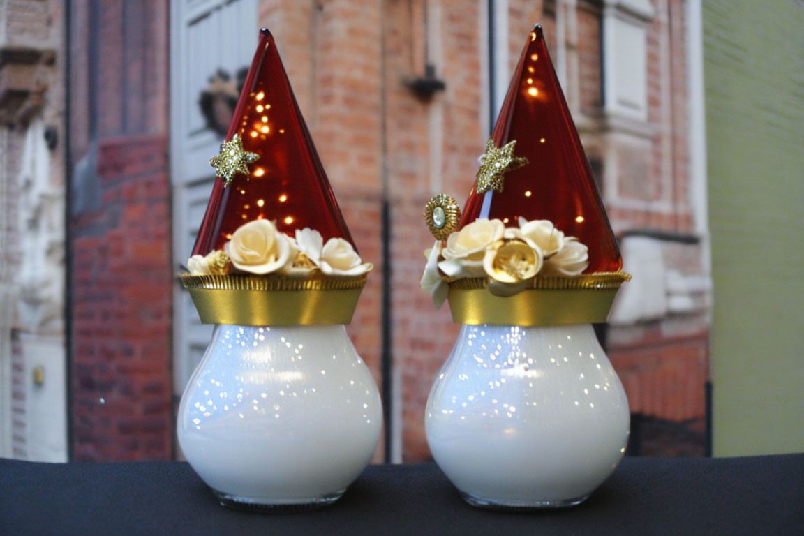 Decorative Santa Claus Christmas lights with red hats and white bases indoors