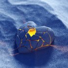 Gold Filigree Heart Pendant on Blue Fabric Background