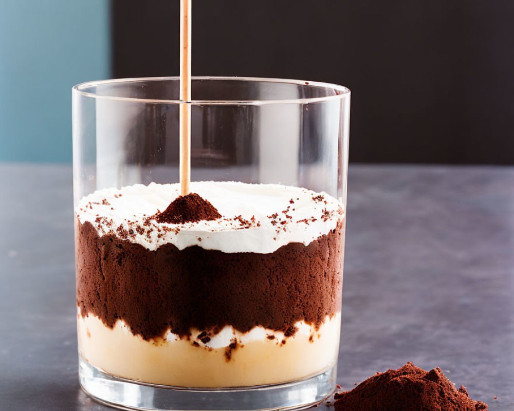 Layered Tiramisu Dessert with Cocoa Powder in Clear Glass