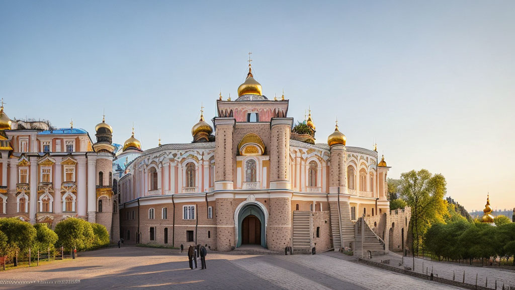 Ornate golden-domed cathedral with white walls and arch entrance at sunset