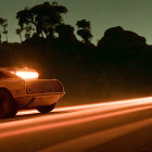 Vintage car with roof lights and rocket exhaust speeding on night road.