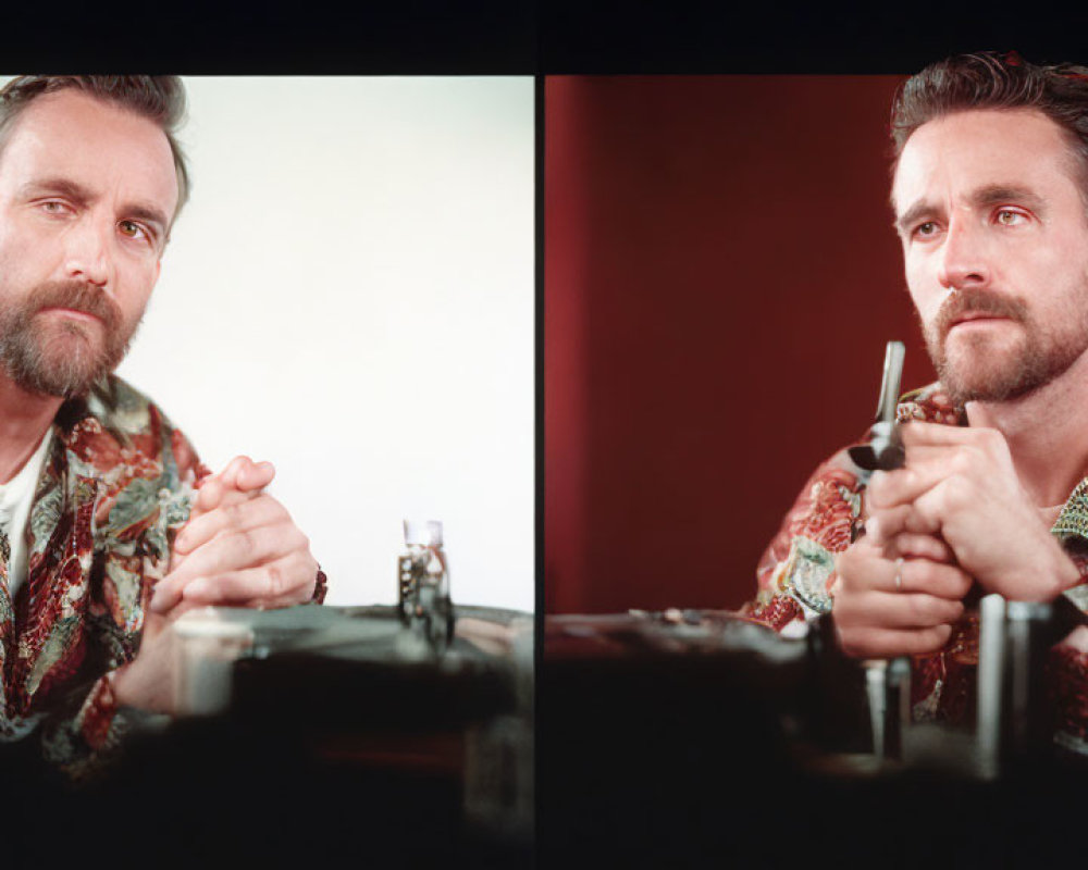 Bearded man in printed shirt holding pen, looking at miniature object