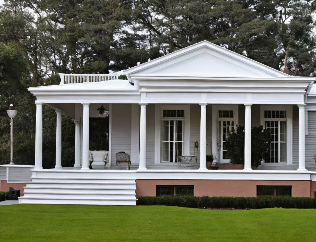 Traditional white house with columns, porch, and green lawn view