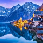 Colorful Village by Lake in Snowy Mountains at Twilight