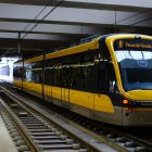 Yellow modern train at indoor platform with sleek design and natural light.