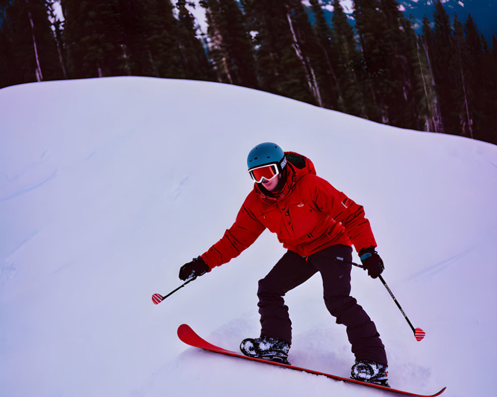 Skier in Red Jacket and Blue Helmet Skiing on Snowy Slope