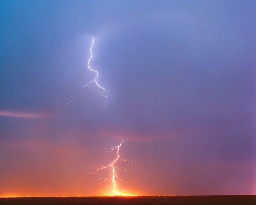 Bright lightning bolt illuminates dusky horizon in flat landscape