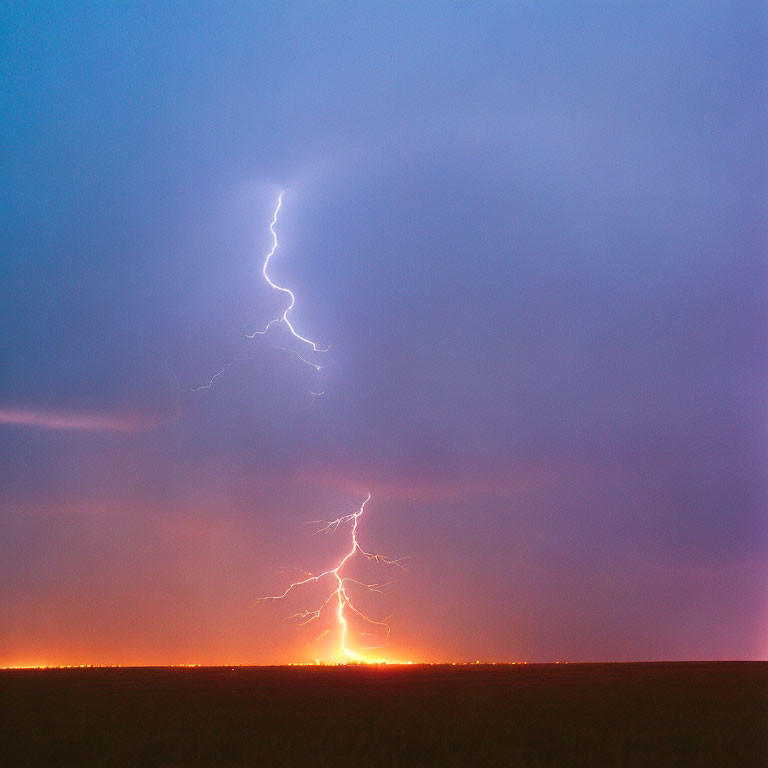 Bright lightning bolt illuminates dusky horizon in flat landscape