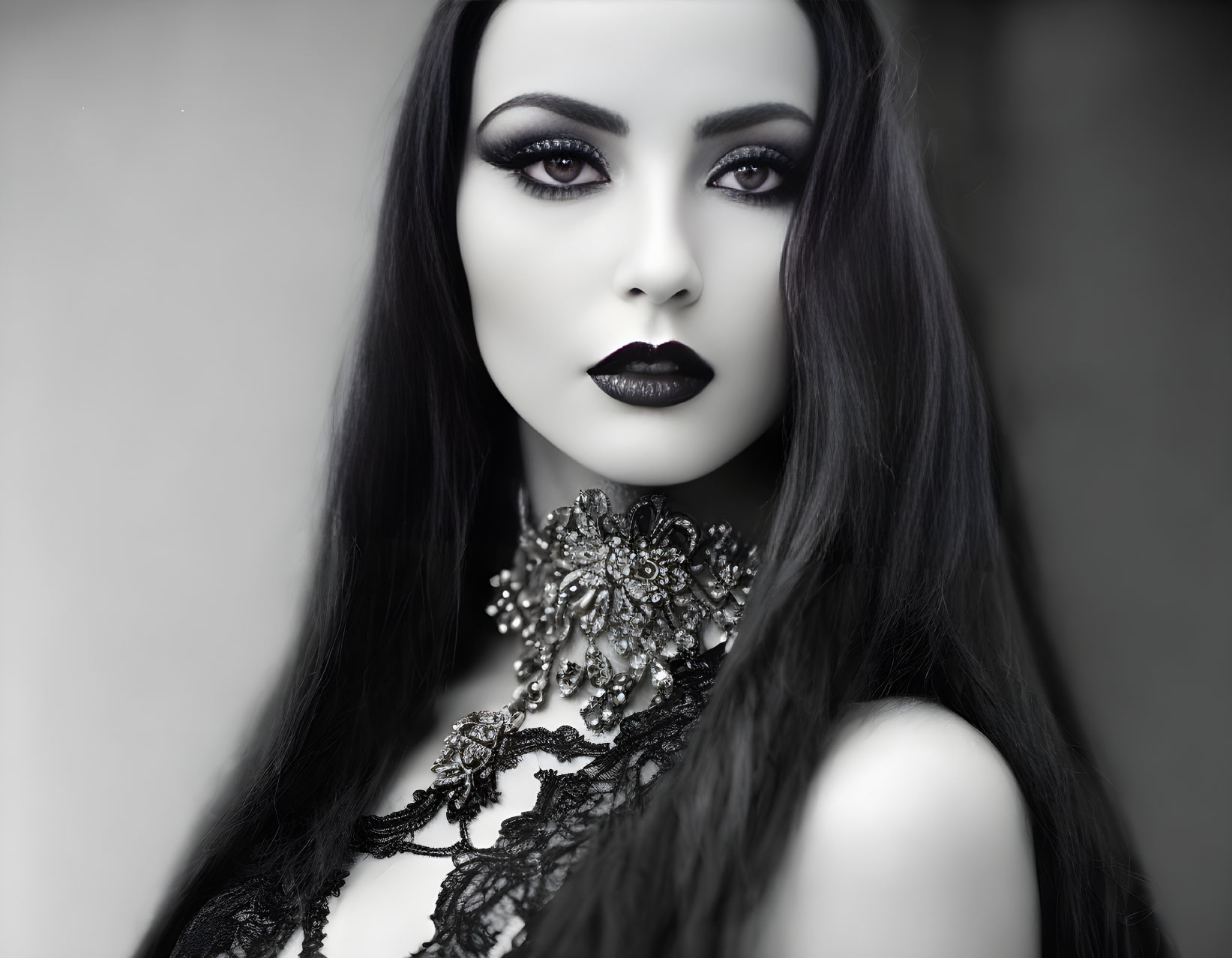 Monochrome portrait of woman with dark lipstick and lace choker