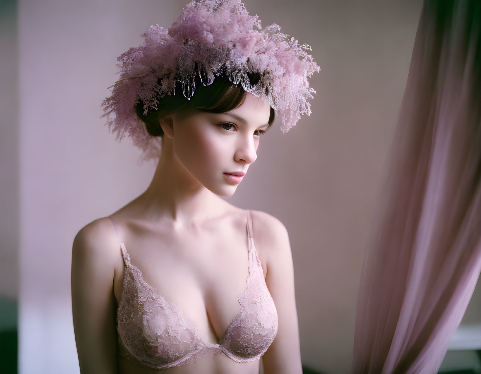 Woman wearing delicate flower crown in soft pink lace-trimmed garment