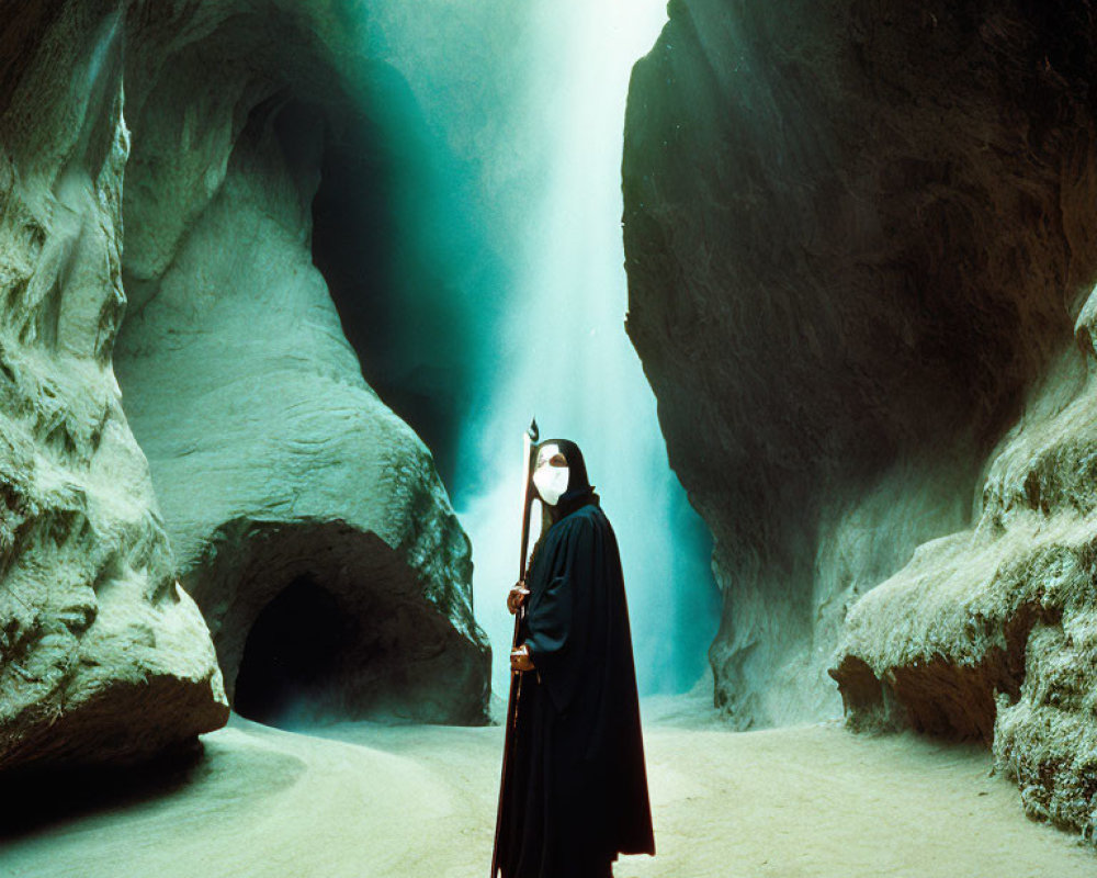 Mysterious figure in black cloak and mask in cave with light shaft