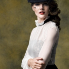 Vintage Attired Woman in Top Hat and Red Lipstick on Neutral Background