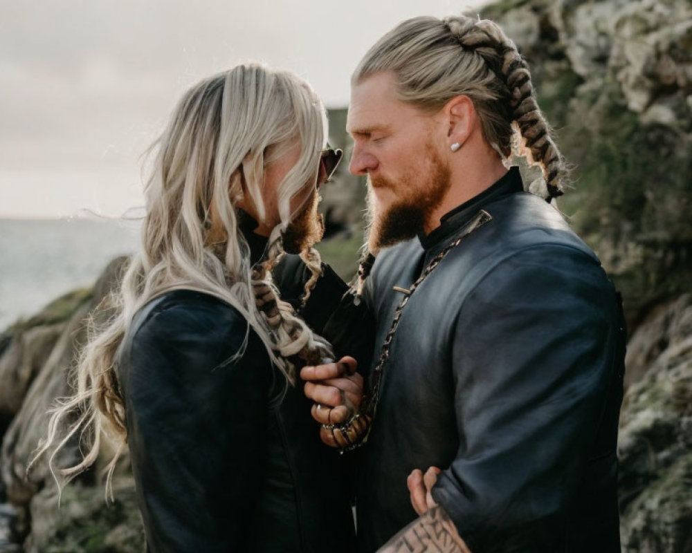 Couple with Braided Hair in Viking-Inspired Leather Outfits by Seaside Cliffs