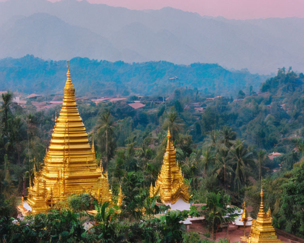 Golden Pagodas Surrounded by Greenery and Mountains at Twilight