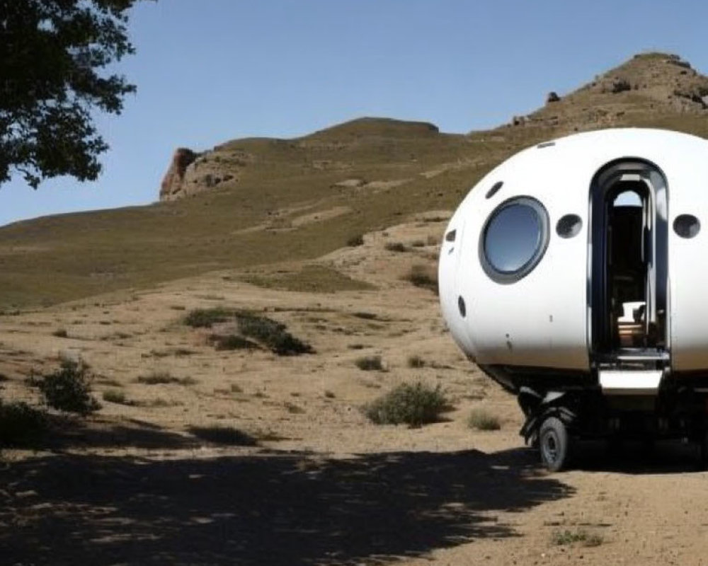 Futuristic capsule trailer in desert landscape