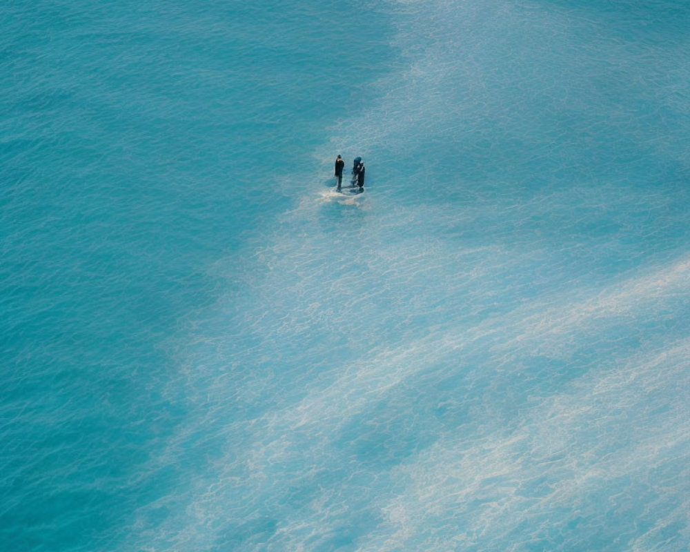 Two people on paddleboard in serene blue ocean