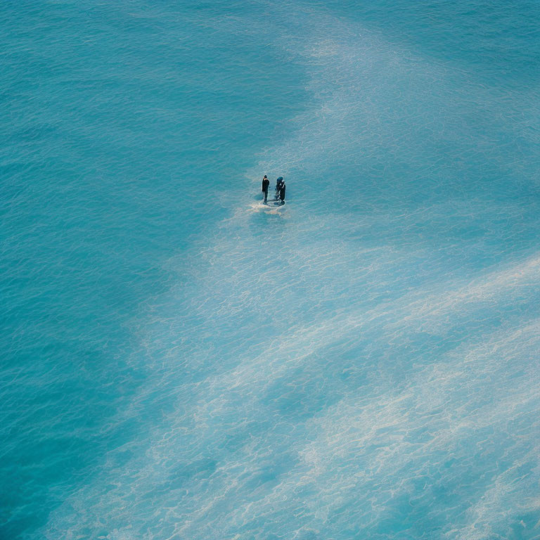 Two people on paddleboard in serene blue ocean