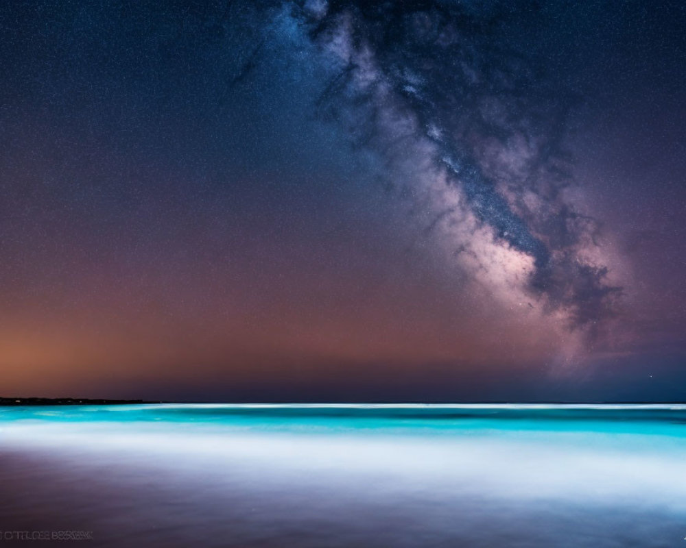 Starry Night Sky with Milky Way over Blue Shoreline at Twilight