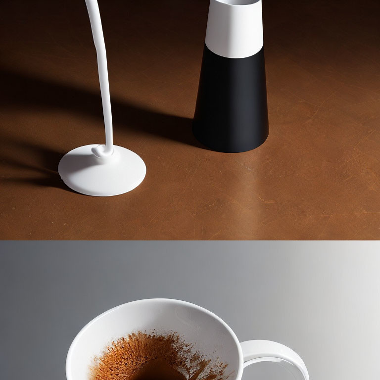 Two-tone desk lamp and white cup on brown surface.