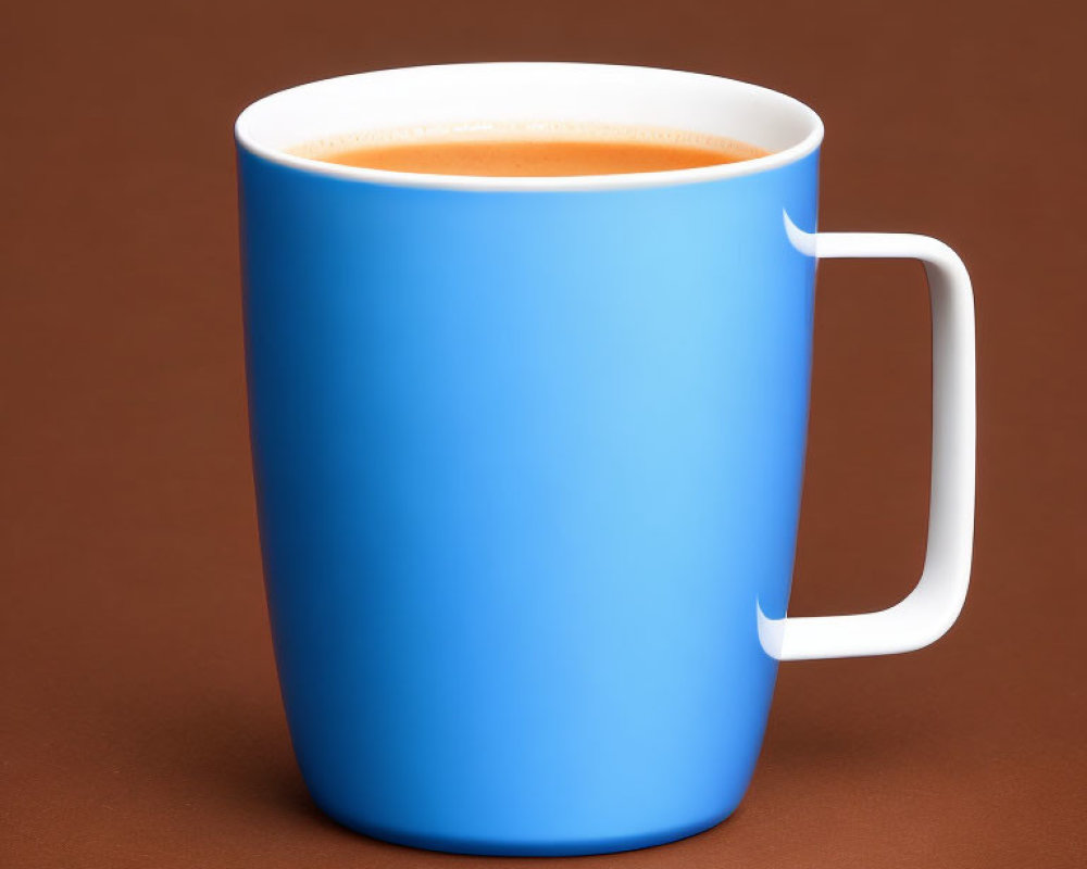 Blue Mug with Frothy Beverage on Brown Background