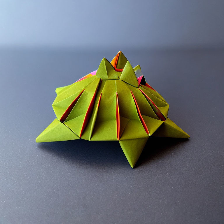 Green Modular Origami Pyramid Structures on Gradient Blue Background