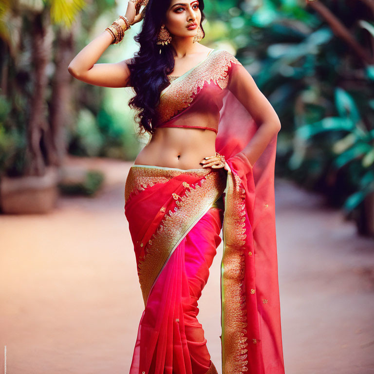 Traditional Indian Woman in Red and Gold Sari Poses in Garden