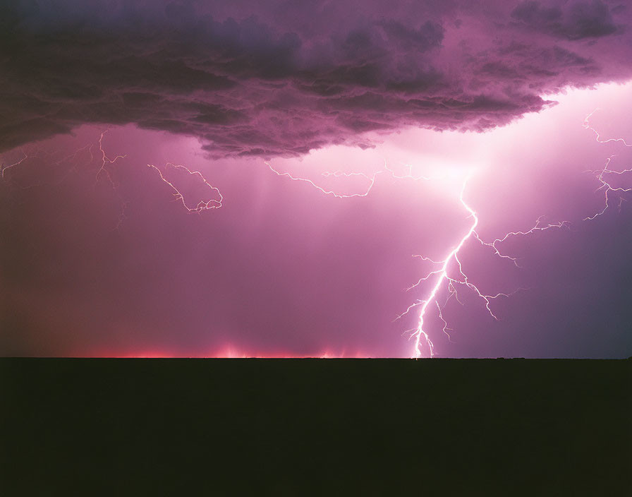 Intense lightning bolts in purple-tinted sky