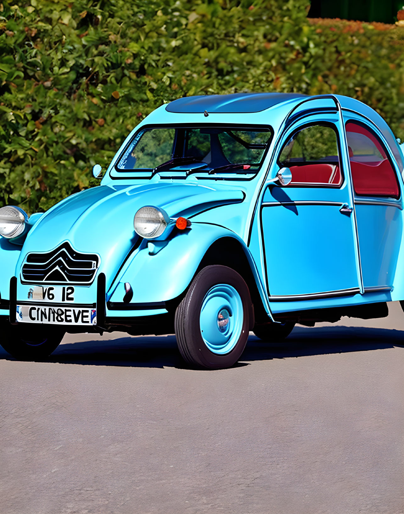 Vintage Sky Blue Citroën 2CV Car with Open Door on Sunny Day