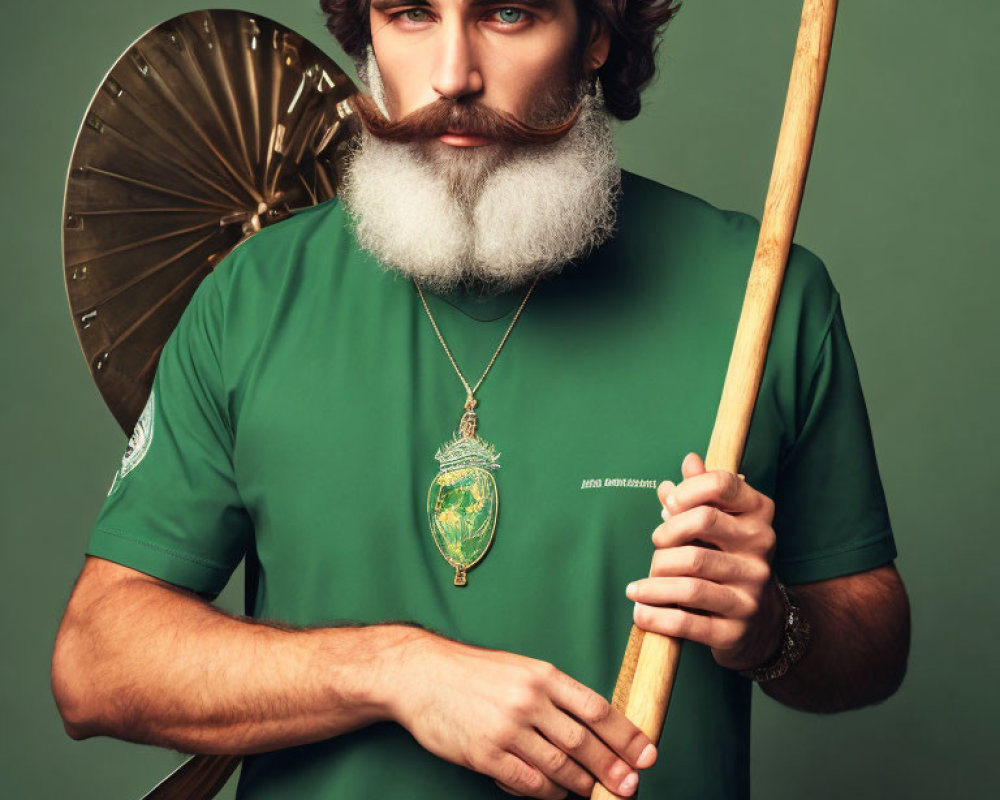 Bearded man with spear, shield, and medallion in green t-shirt