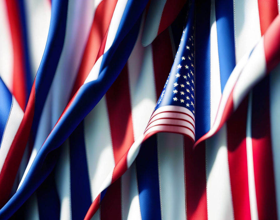 Detailed view of American flag folds: stars and stripes in red, white, and blue.