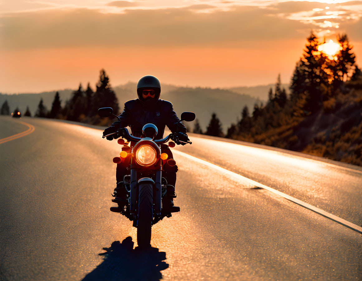 Motorcyclist on Highway at Sunset with Warm Glow