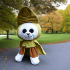 Plush Toy Rabbit in Detective Costume Among Autumn Leaves