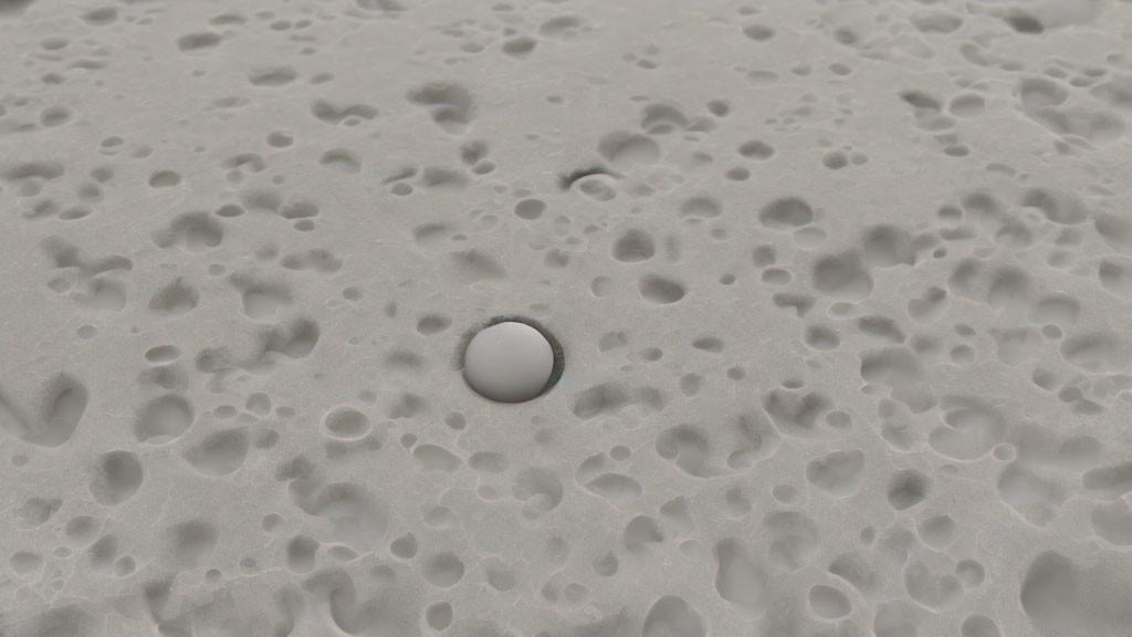Spherical object on cratered grey surface reminiscent of moon landscape
