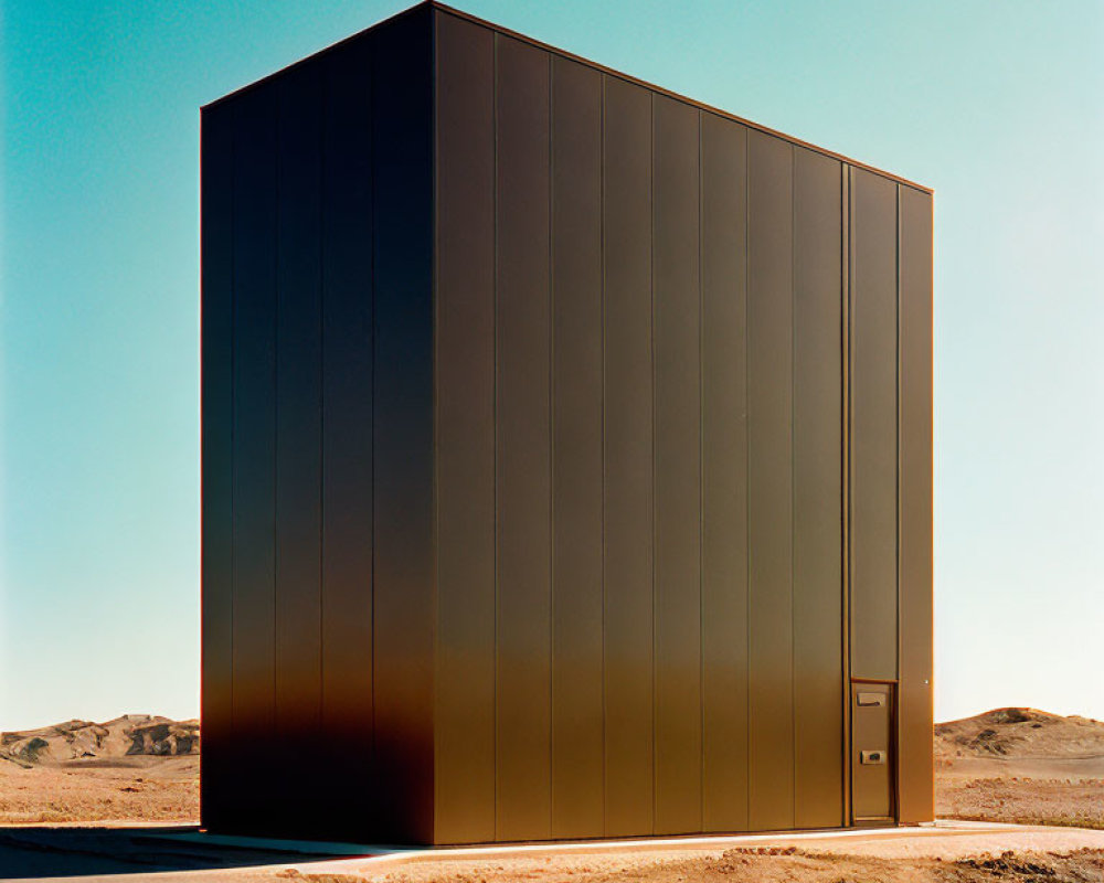 Monolithic dark brown structure in desert landscape