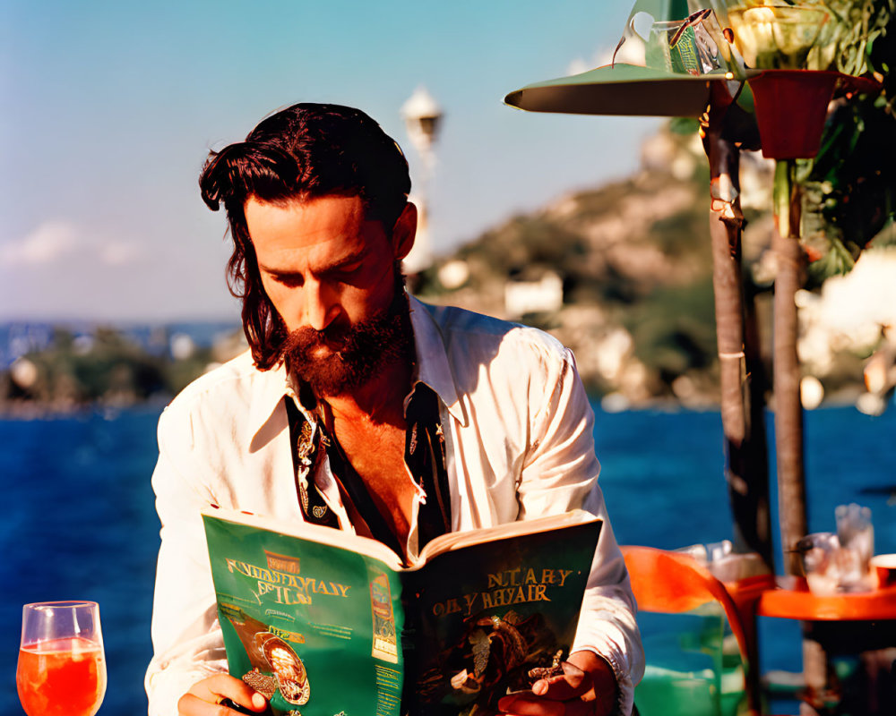 Bearded man reading menu at seaside restaurant with ocean view