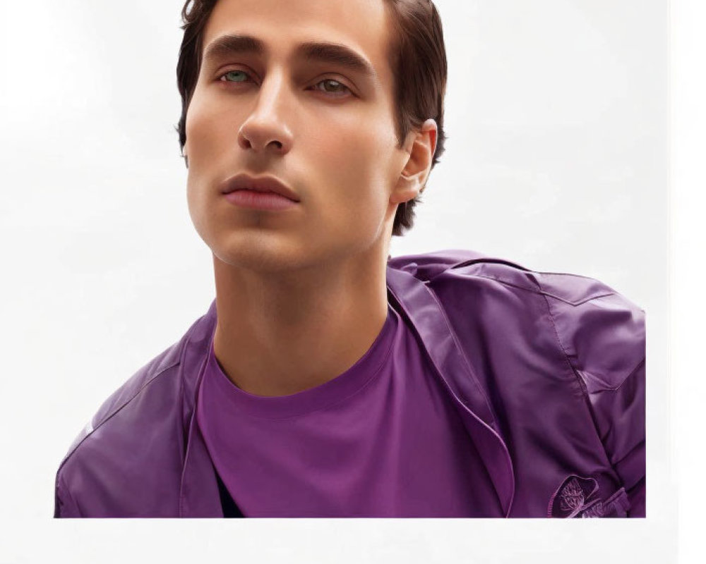 Man with Slicked-Back Hair in Purple Jacket on Light Background