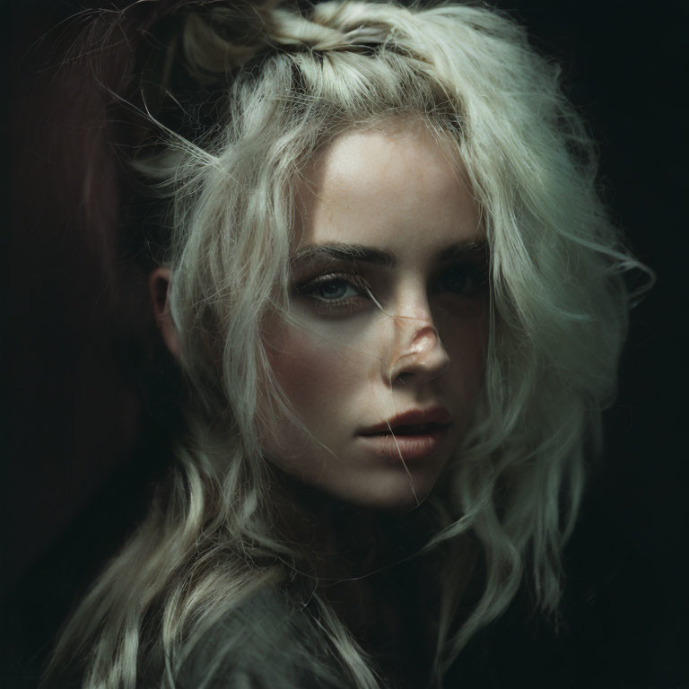 Blonde Woman Portrait with Tousled Hair and Shadowy Background