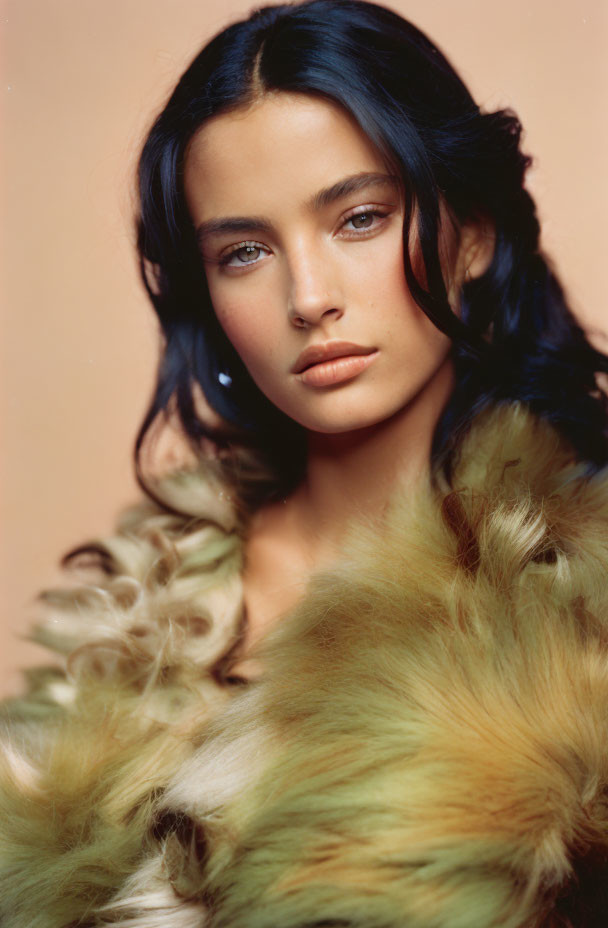 Woman with Wavy Dark Hair in Green and Yellow Fur Garment