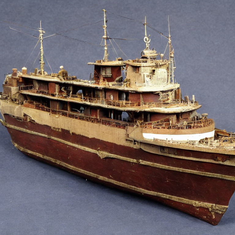 Detailed Scale Model Ship with Multiple Decks and Antennas on Blue Background