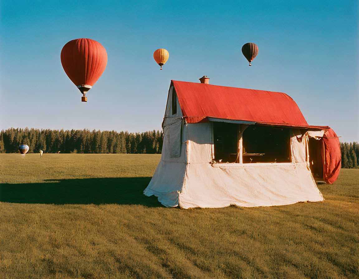 Canvas Tent with Red Roof in Grassy Field, Four Hot Air Balloons in Sky