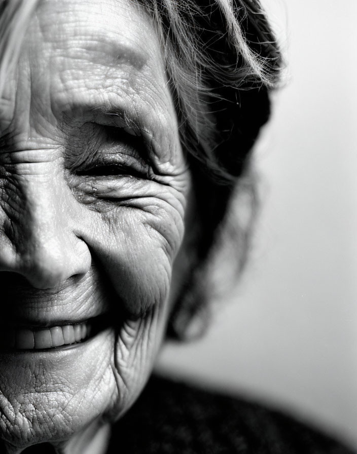 Elderly Woman Smiling with Deep Wrinkles in Black and White