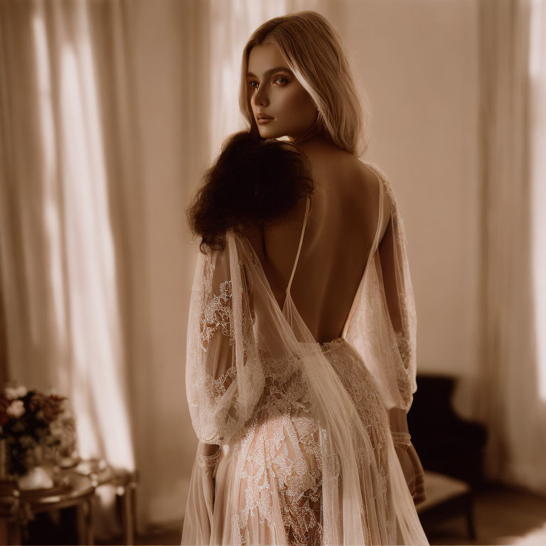 Elegant woman in lace robe with open back in softly lit room