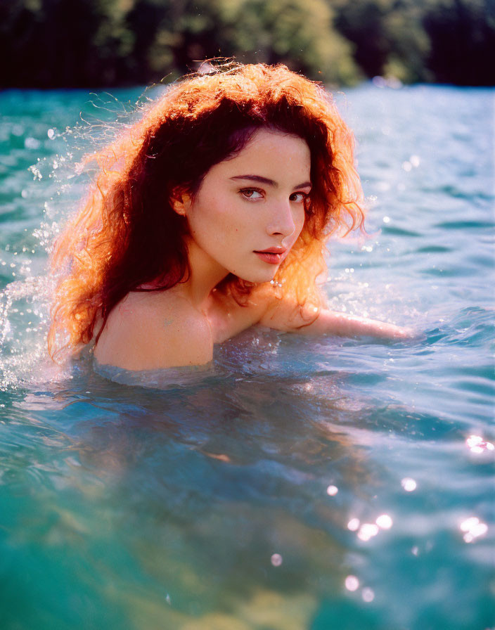 Reddish-Haired Woman Swimming in Clear Blue Water under Sunlight
