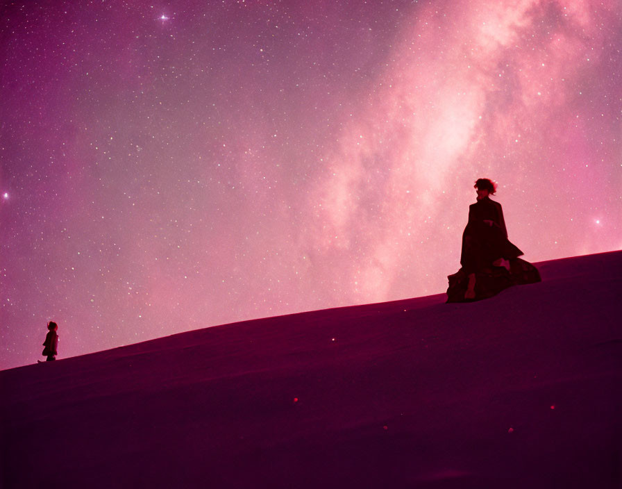 Silhouette of person on sand dune under pink starry sky with figure below