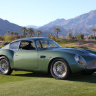 Vintage Blue Aston Martin DB5 on Grass with Rolling Hills Background