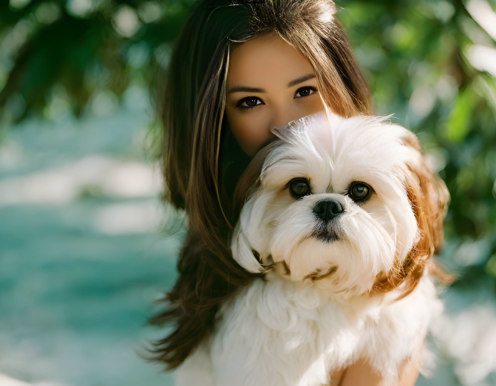 A beautiful girl with a Shih Tzu at the park