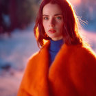 Fair-skinned woman in orange faux fur coat under golden sunset light
