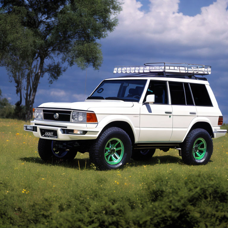 Vintage White SUV with Green Rims Parked in Grass Field